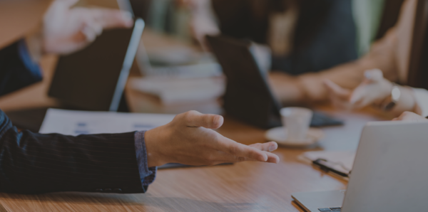 A discussion takes place in a corporate office